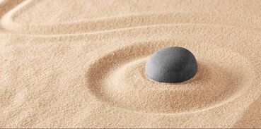 Smooth rock in the sand. Mindfulness, DBT for trauma, DBT for teens, intersectional therapy, multicultural therapists and trauma-informed practice in Ewing, NJ